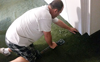 Man Repairing Carpet
