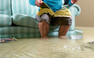 Photo of a man in a flooded room.